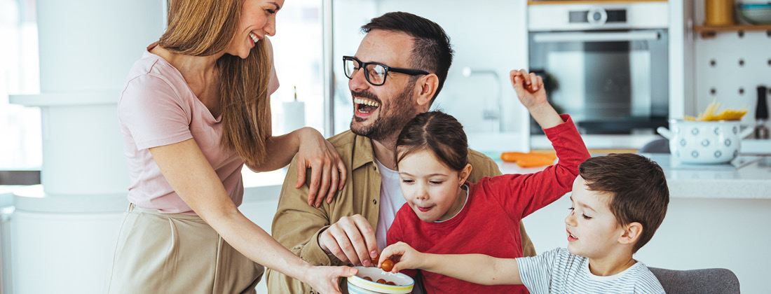 A healthy family around the table eating vegetables