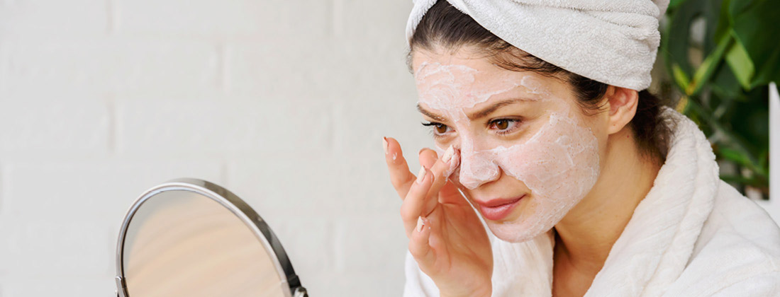 a lifestyle image of a person doing her skincare routine