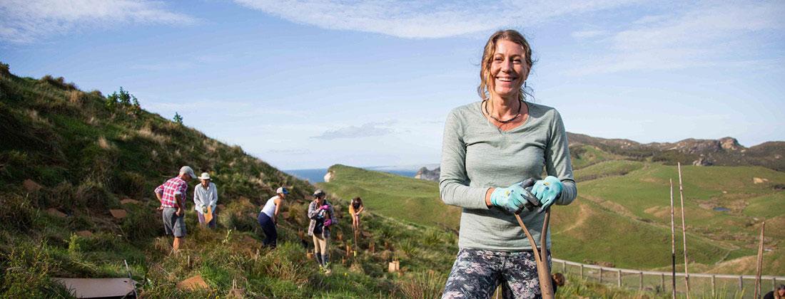 A-woman-with-her-team-at-HealPost-gardening-infromt-of-Healthpost-nature-trust