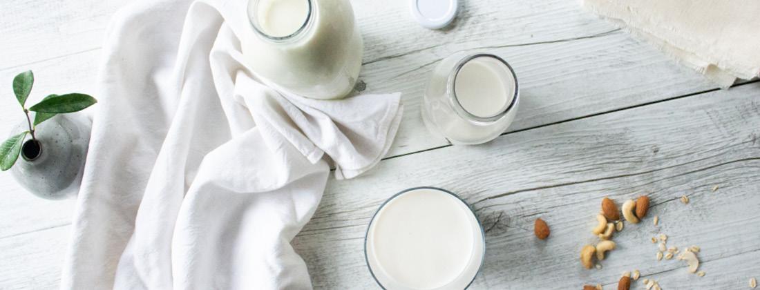 Aerial View of Cheesecloth And Milk In Glass To Make DIY Nut Mylk 