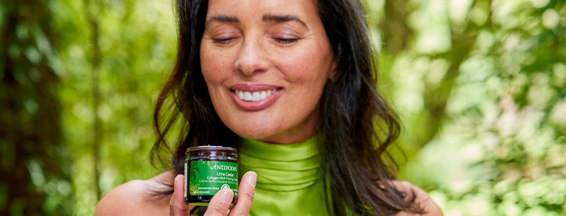 woman in nature with skincare product