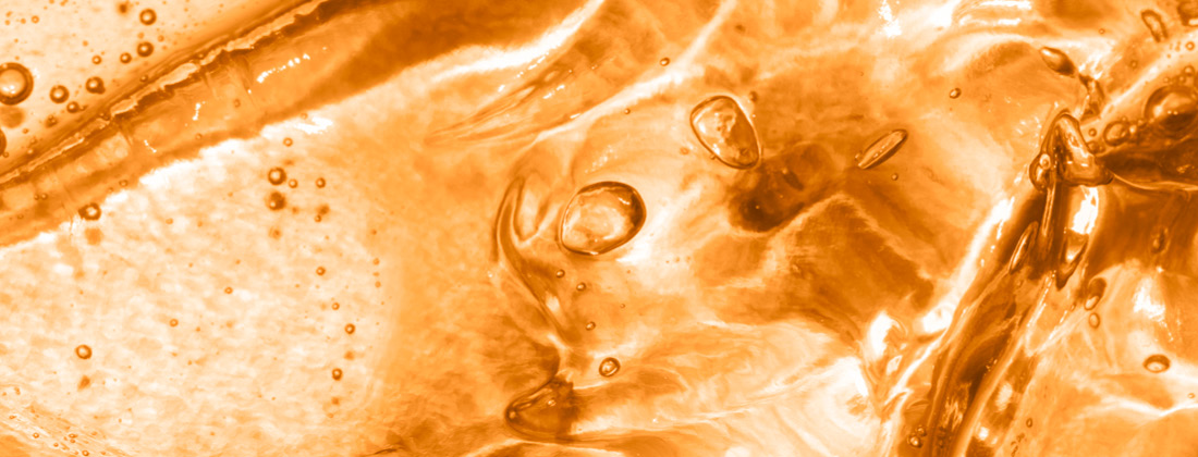 Close up of clear orange liquid Vitamin C Skin Serum