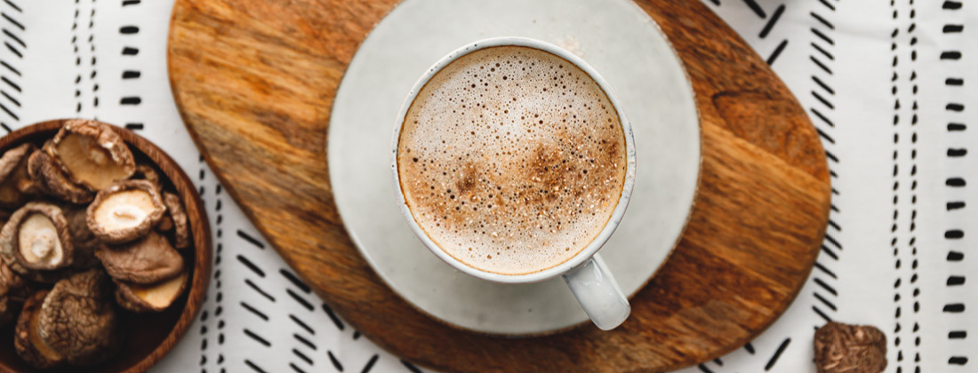 Close up of cup of coffee and bowl of mushrooms 9 Fantastic Functional Mushrooms To Match Your Health Goals