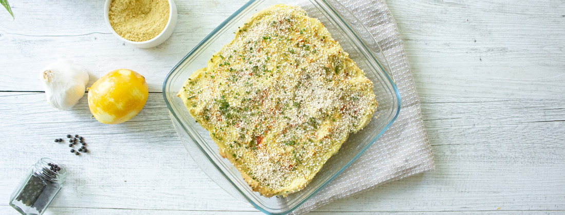 Freshly served Vegan Scalloped potatoes on white plate with fork 