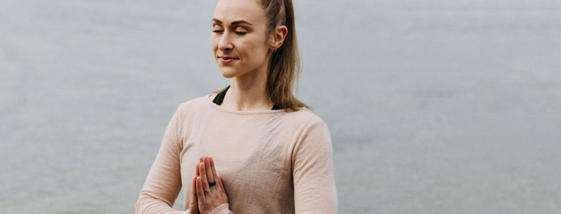 Woman meditates outdoors