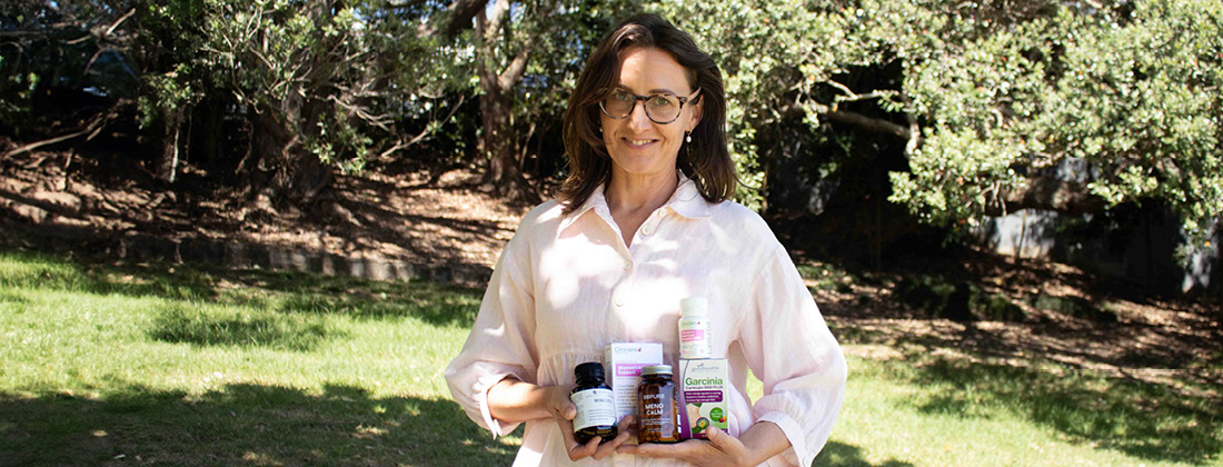 Naturopath Rebecca holding HealthPost menopause products
