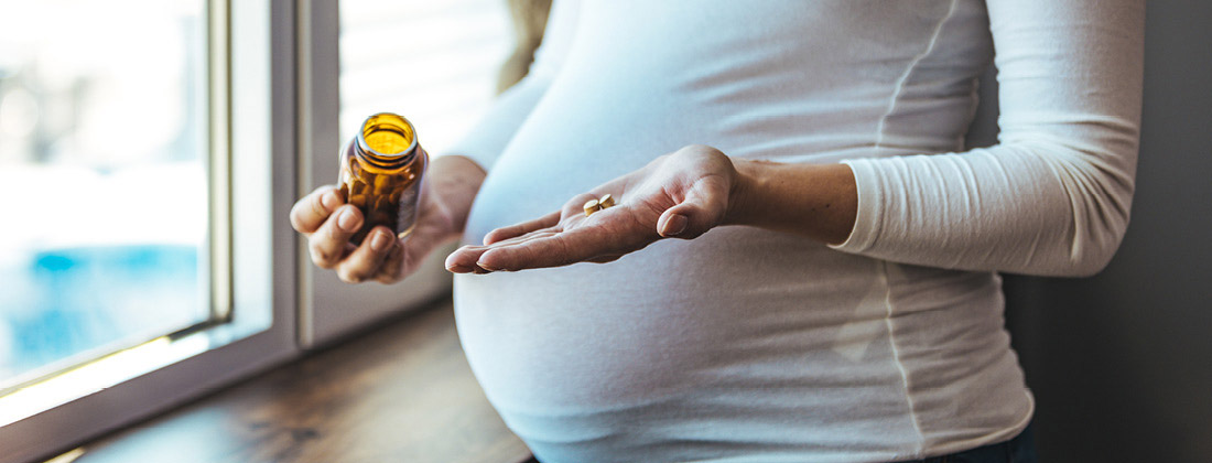 Woman holds supplements in hand