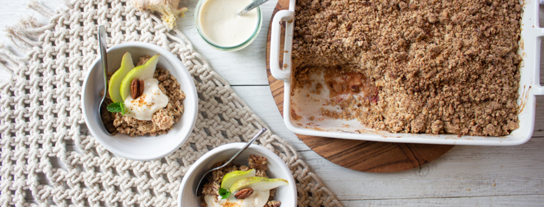 Rhubarb, Pear and Ginger Crumble cut and served into bowls sitting on table 