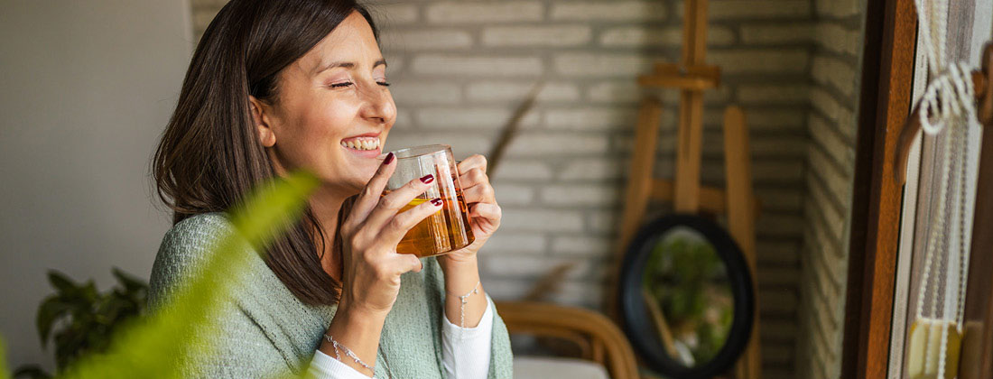 Woman happily drinks beverage