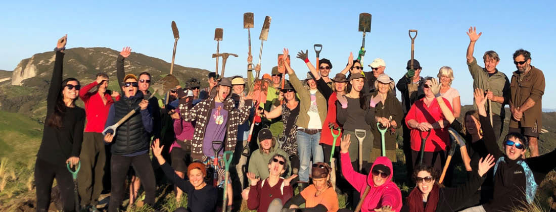 The HealthPost Team Cheers For A Photo After Tree Planting