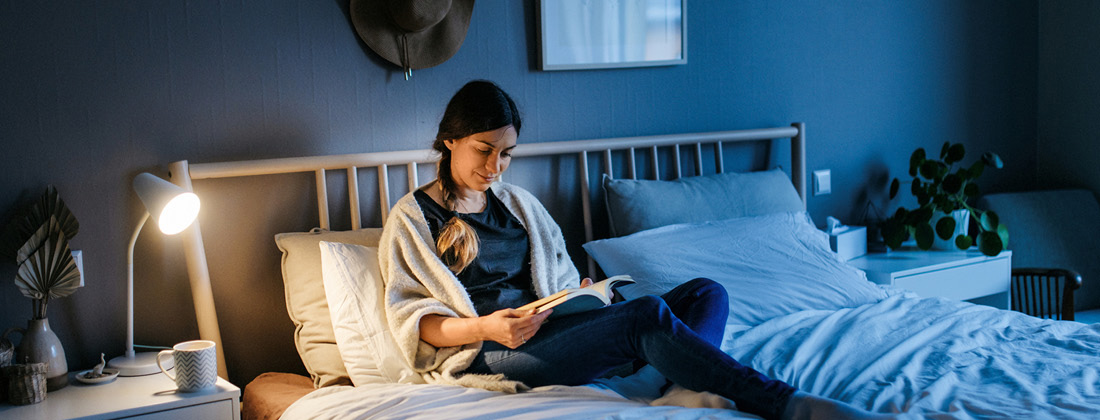 Woman Reading In Bed Before Sleep