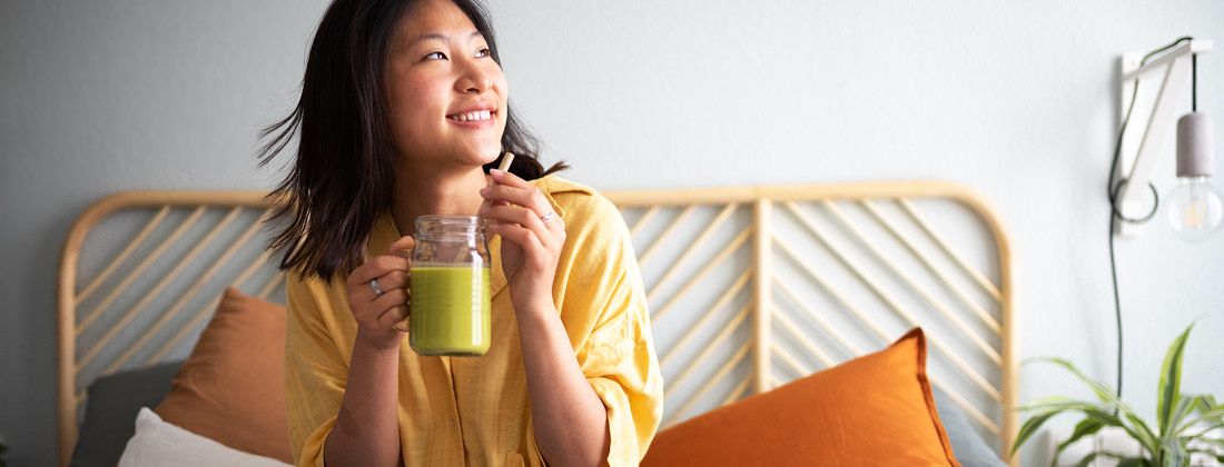 Woman relaxing drinking a nourishing healthy smoothie